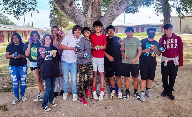 Class of 2023 group photo under a tree